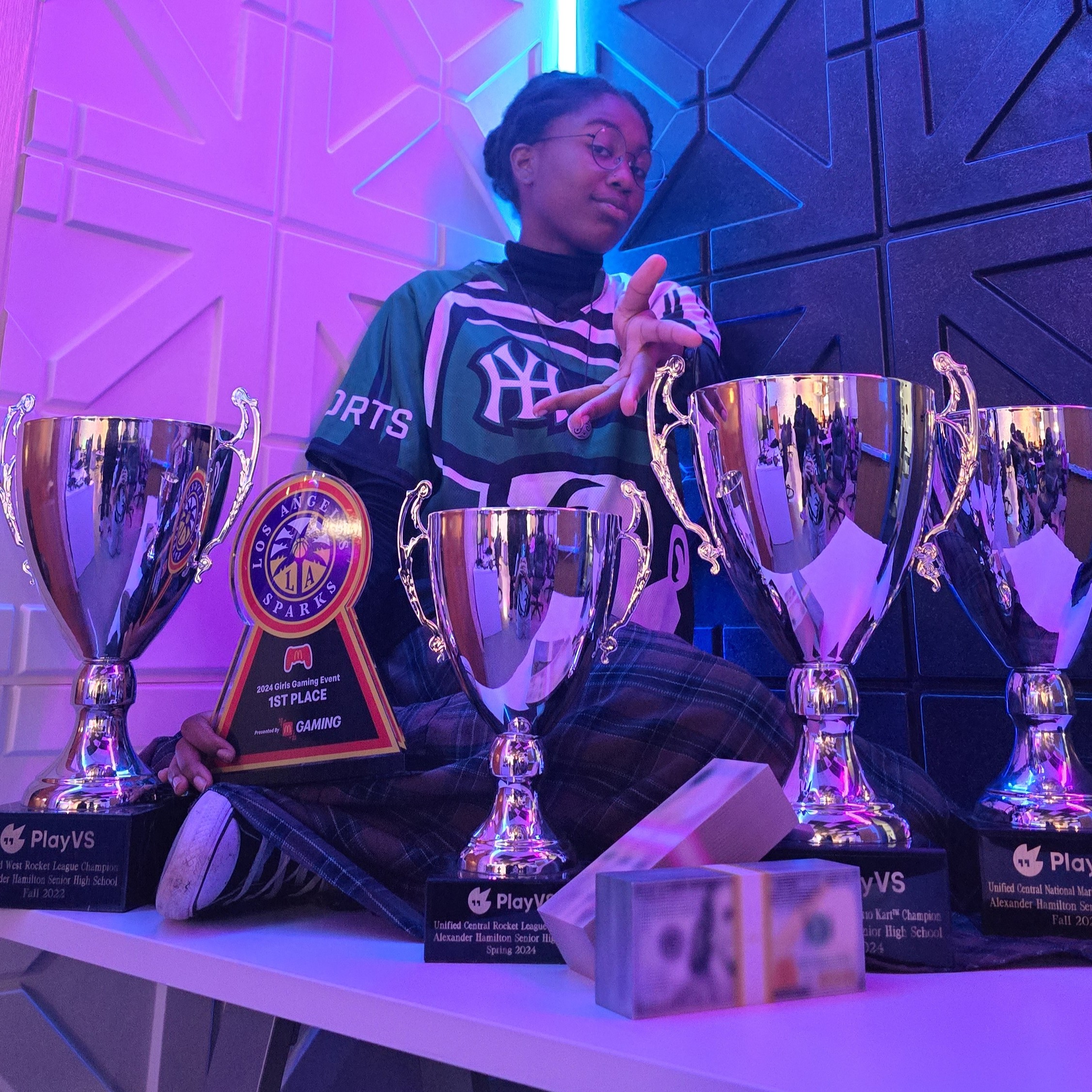 Hamilton Esports player with championship trophies