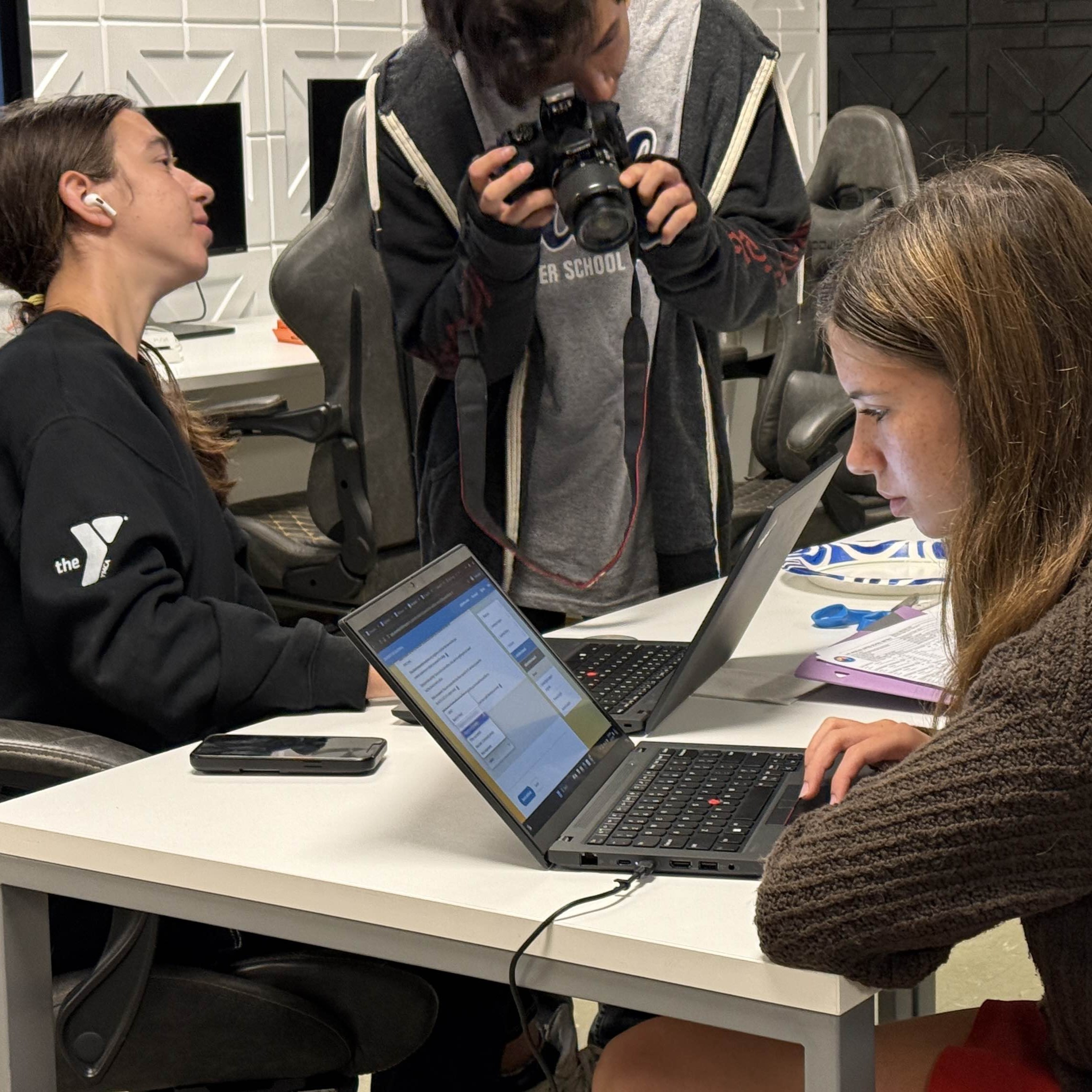 Students engaging in the lab on laptops